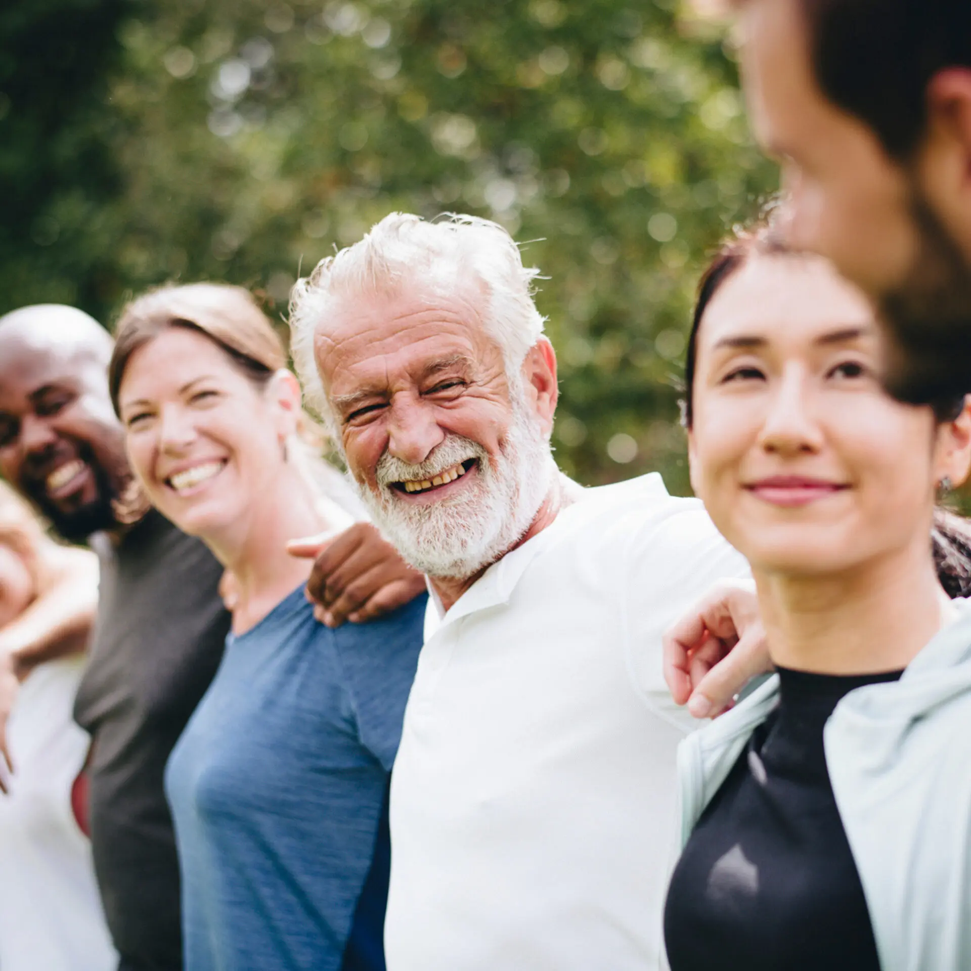 people standing in line with their arms around each others backs