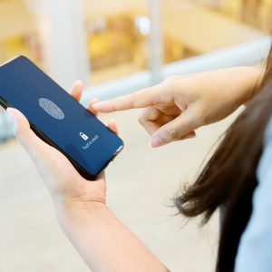 woman unlocking phone with scan fingerprint biometric identity