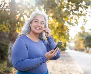 woman putting in headphones getting ready to exercise