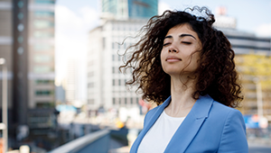 woman in blazer standing in front of building