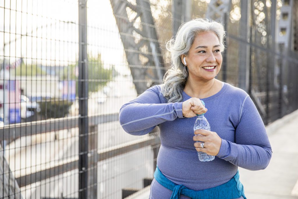 Woman with water bottle walking