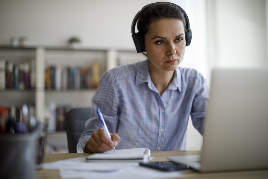 woman listening on laptop