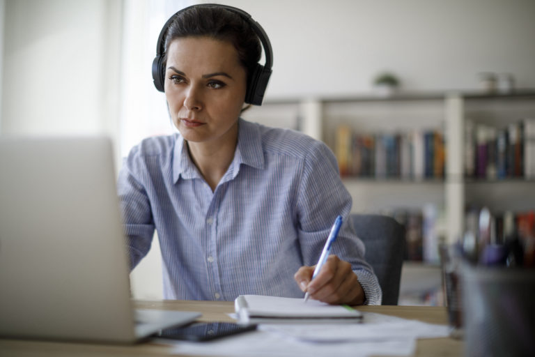 woman listening on laptop
