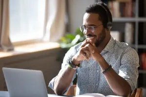 Man with headset on laptop