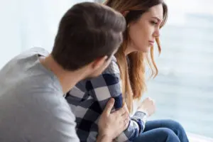 Man comforting woman