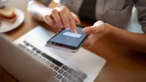 Phone and laptop with hands