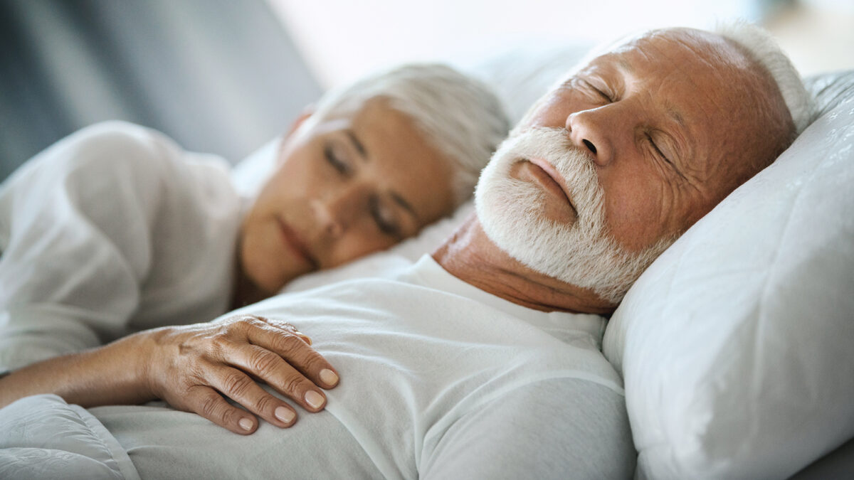 Mature couple sleeping in bed