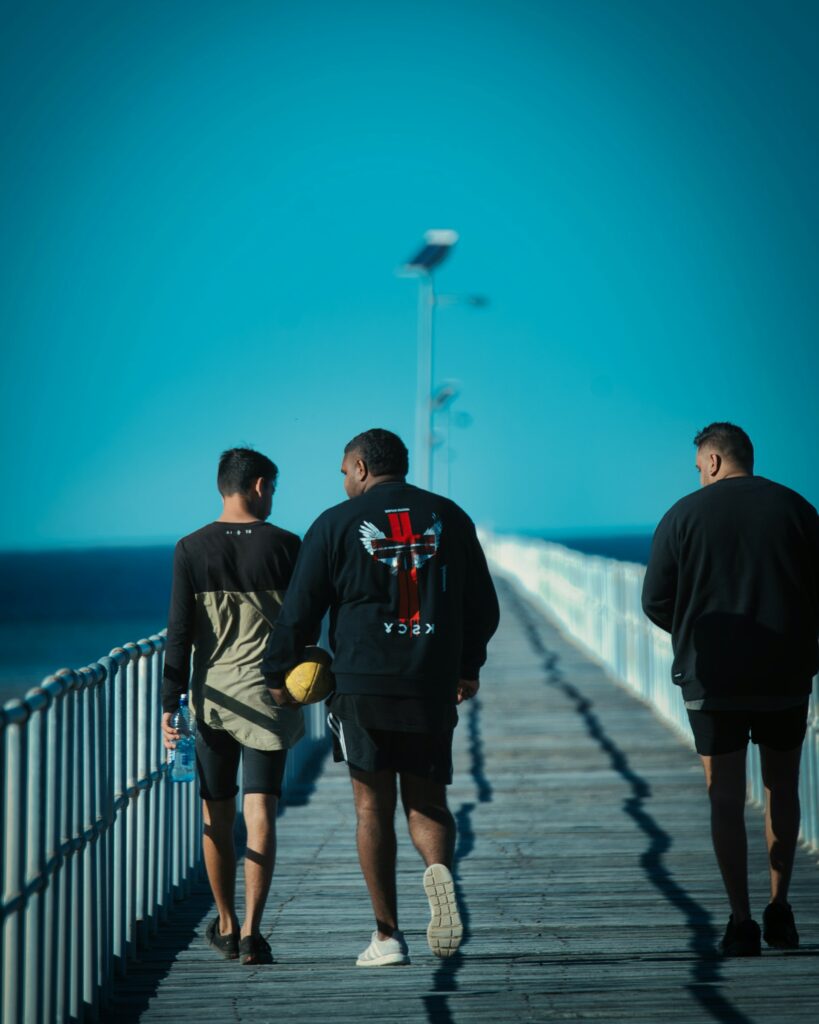 Men walking on a pier