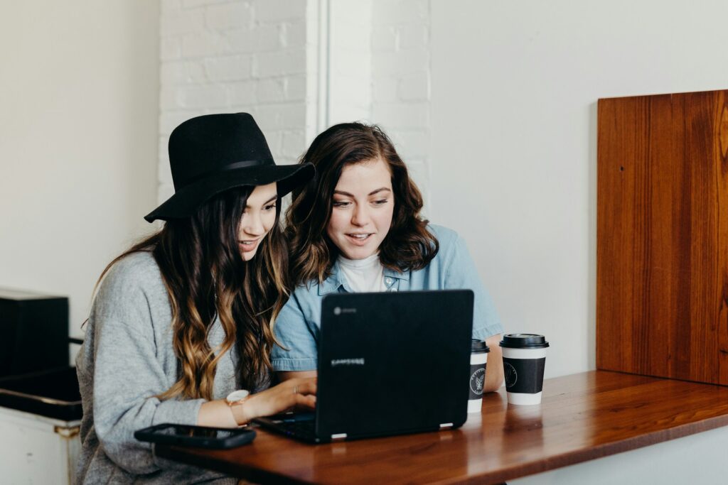 Better Recovery Outcomes with Digital Health Coaching 1 Two women looking at a laptop, discussing digital health coaching options