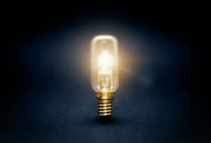 See the Impact: Avidon Health Coaching Efficacy Report 4 Light bulb glowing on a dark background, representing innovation behind Avidon Health’s new digital wellness platform for small businesses.