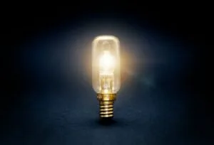 Light bulb glowing on a dark background, representing innovation behind Avidon Health’s new digital wellness platform for small businesses.