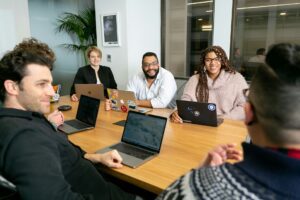 Report: Organizational Costs of Unhealthy Habits 4 A diverse team collaborating in a modern office—key to an inclusive employee wellness program.