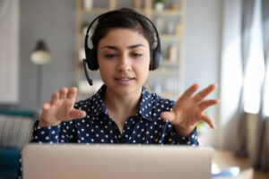 Woman leading a virtual health coaching session from home, demonstrating digital health coaching in action.