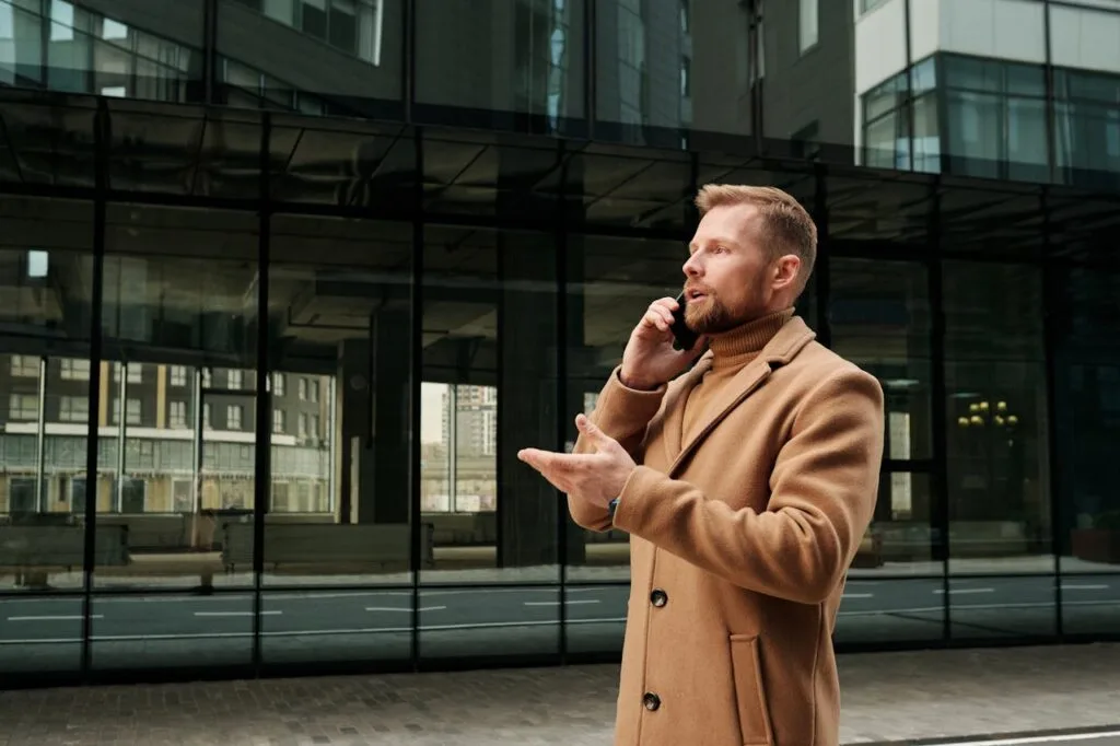A man outdoors on a phone call, representing a walking meeting in a remote work context.