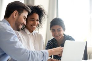 HR team reviewing employee wellness software on a laptop during platform selection