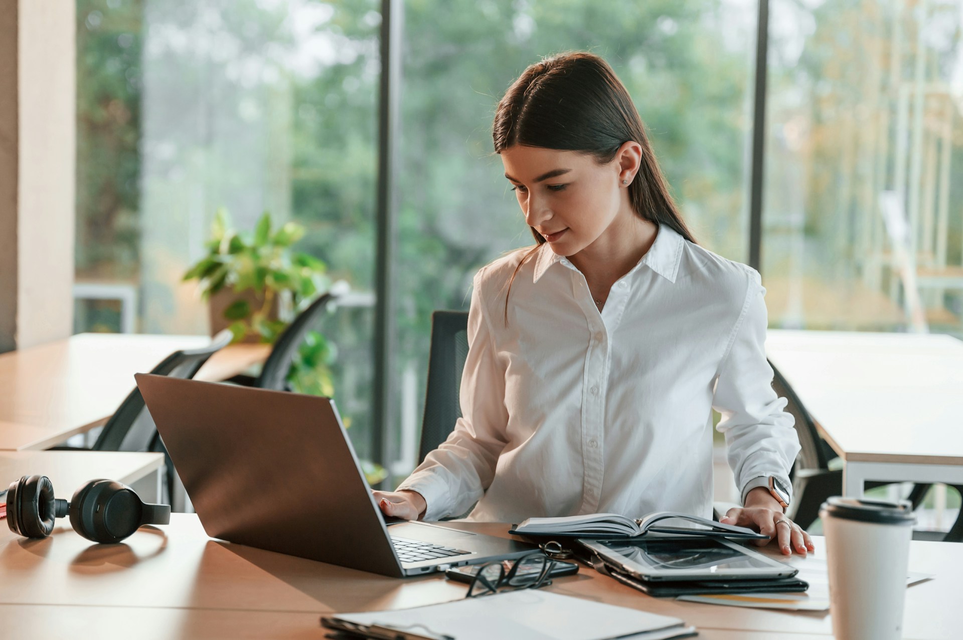 Employee wellness participation and communication strategies HR professional reviewing employee wellness participation data on a laptop