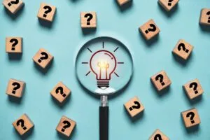 Lightbulb surrounded by question marks illustrating how habits work