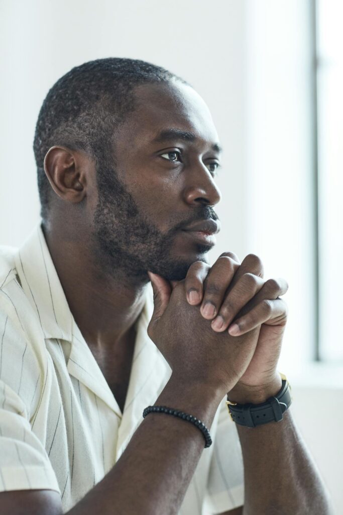 Man in a thoughtful pause representing mindfulness and emotional self-regulation in behavior change