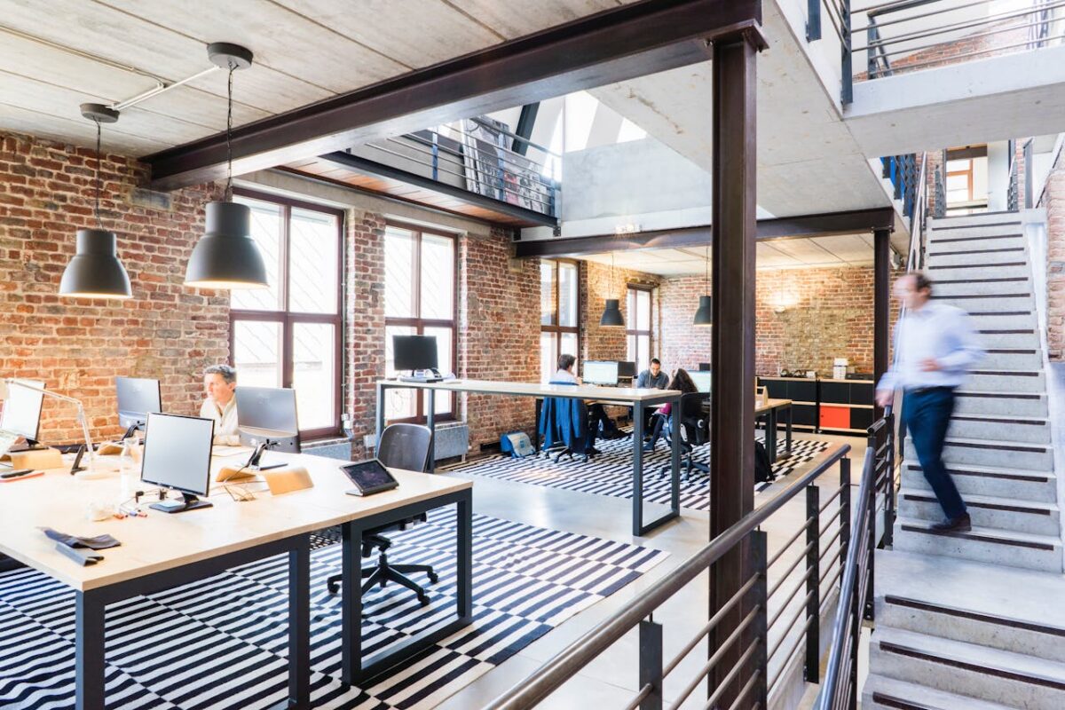 Employees working in a modern open office environment at a small business workplace