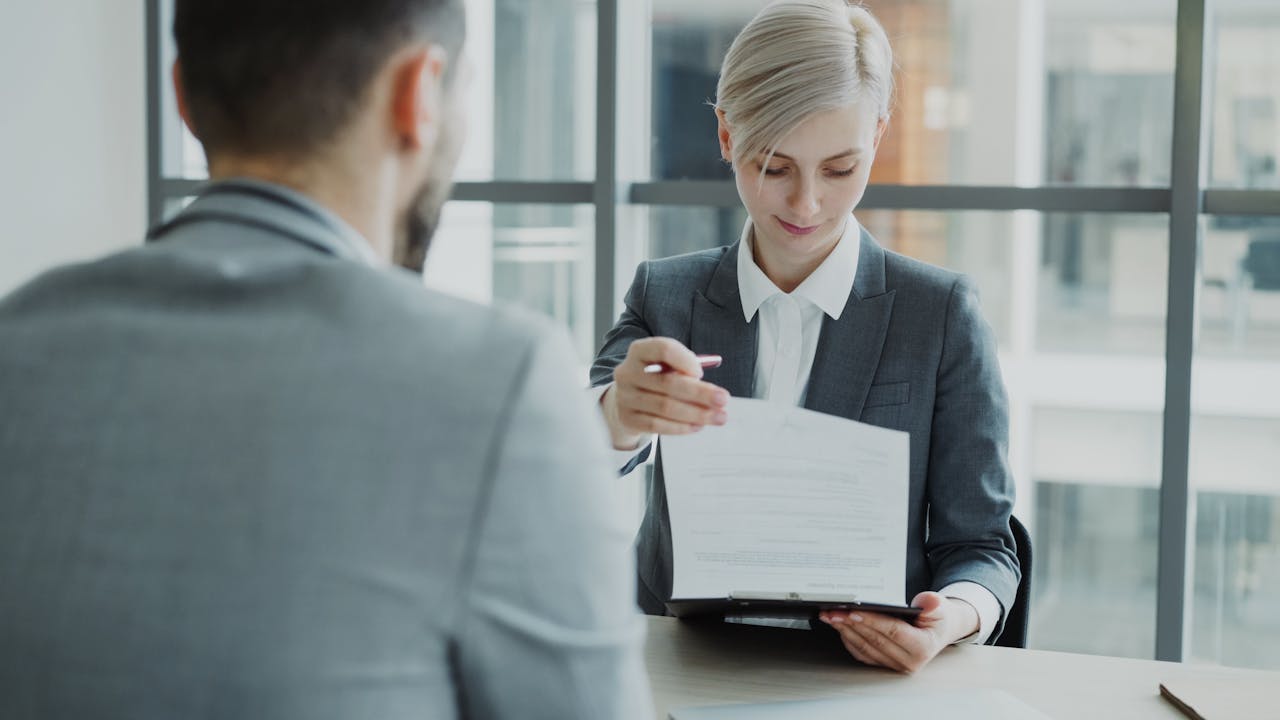 GLP-1 ADA employer compliance review HR professional reviewing GLP-1 ADA compliance documents before open enrollment