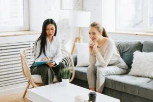Health coach taking notes during an in-person coaching session with a engaged member