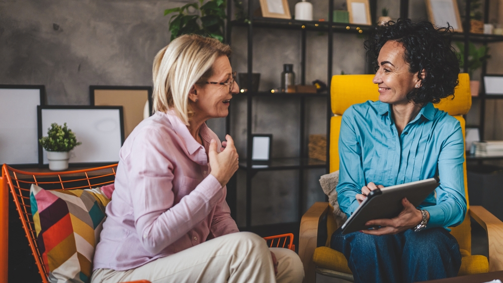Wellness coach meeting one-on-one with a mid-career employee