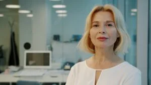 A confident woman standing in a modern office environment