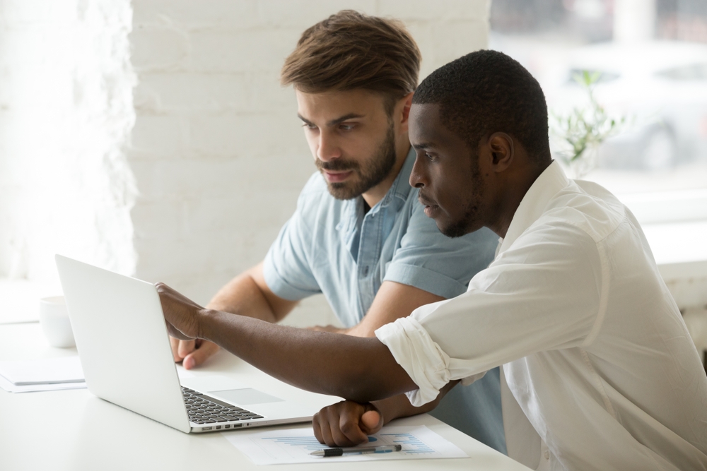 Employees using a digital health coaching platform on a laptop at work