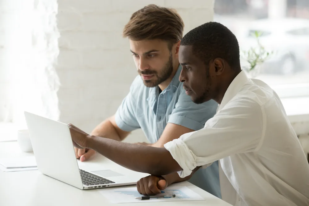 Employees using a digital health coaching platform on a laptop at work