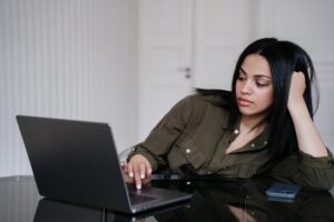 Employee showing signs of silent burnout while working on laptop at desk