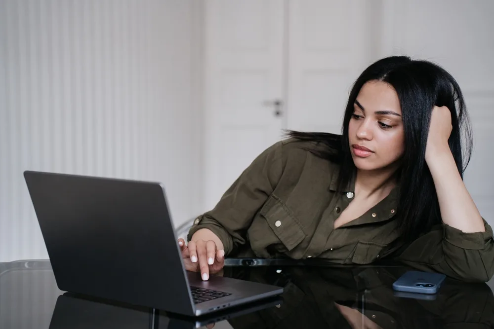 Employee showing signs of silent burnout while working on laptop at desk