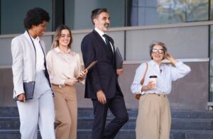 Diverse team of employees walking outside together during a walking meeting