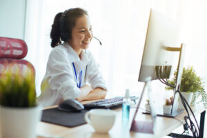 Health coach on a headset working with a client through a digital coaching platform