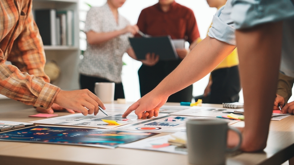 HR team reviewing the 2026 employee well-being report findings together