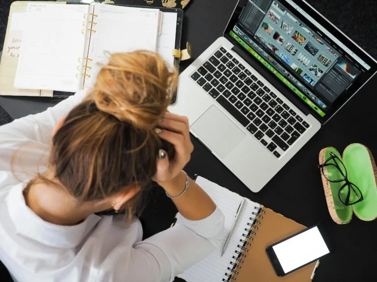 Stressed employee experiencing burnout, a leading driver of employee absenteeism