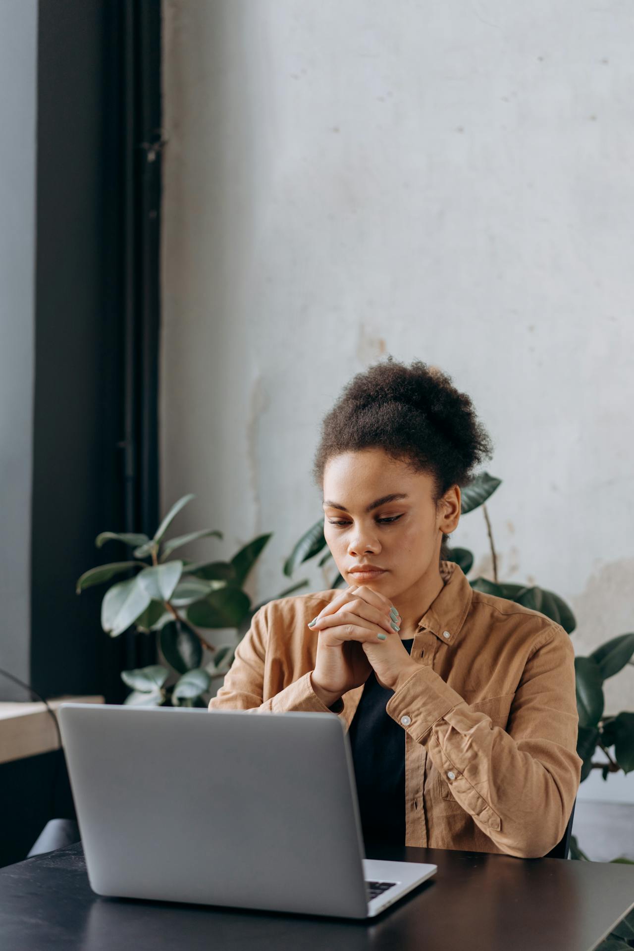 Workplace loneliness at work Disengaged employee sitting alone at a desk experiencing workplace loneliness