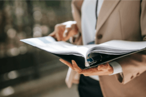 HR manager reviewing corporate wellness trends for 2026 with a binder