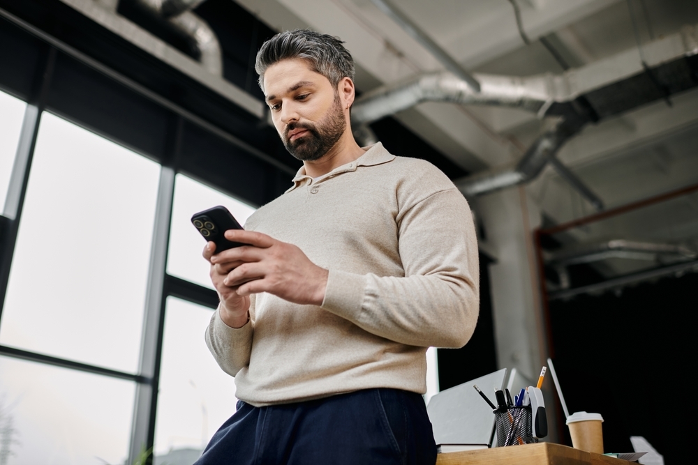 Male employee looking at health and wellness content on his phone