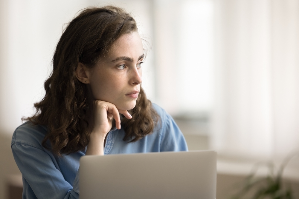 A disengaged employee sitting at a desk, quietly checked out during the Great Detachment