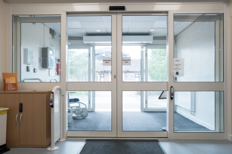 Entrance doors of an outpatient clinic seen from inside the lobby